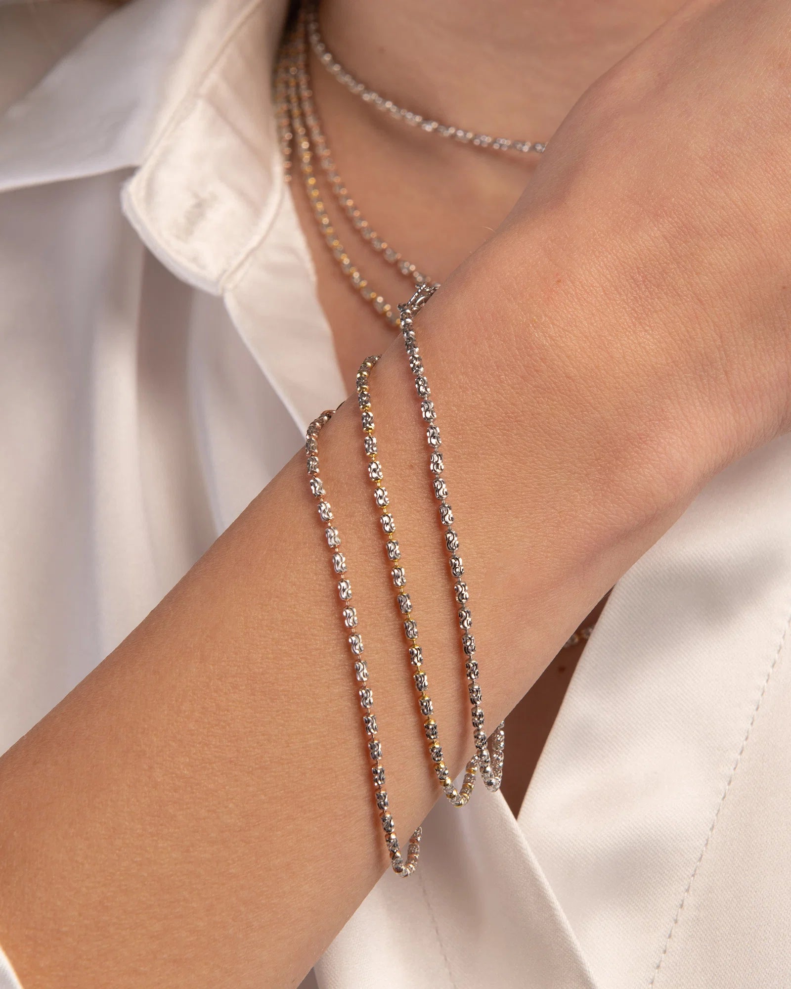 Bracciale Desmos in argento bicolore bianco e rosato a palline ovali piccole