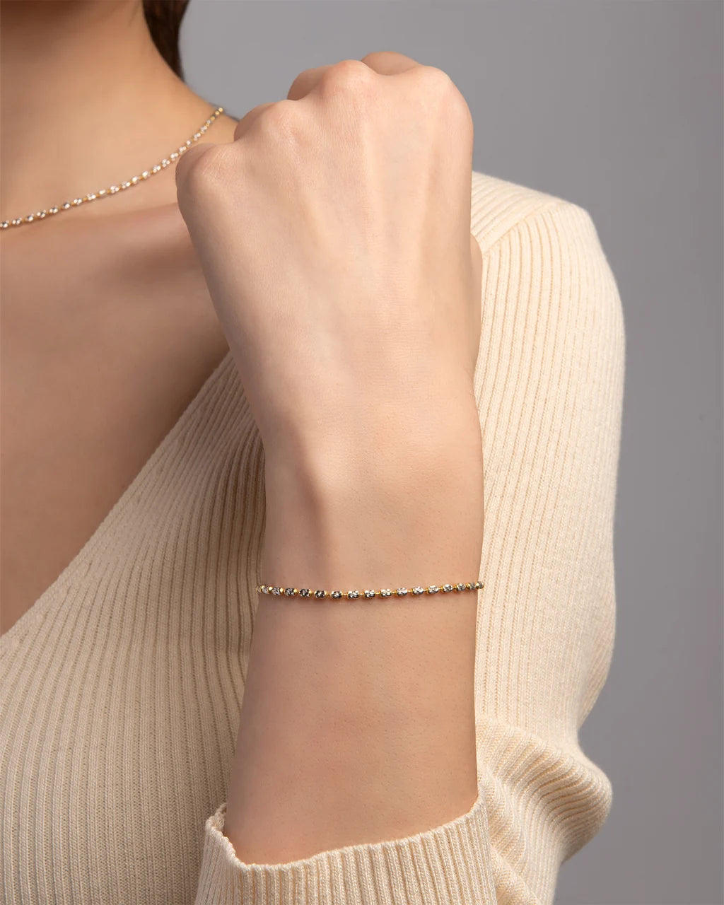 Bracciale Desmos in argento bicolore bianco e dorato a palline ovali piccole
